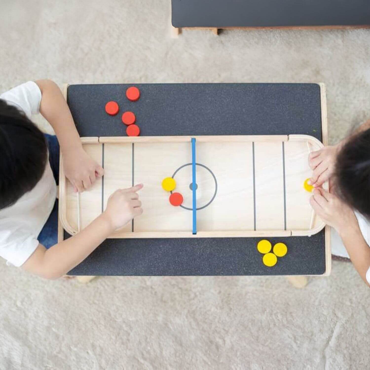 Kids Playing PlanToys 2-In-1 Shuffleboard Game