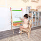 Child drawing on Tiny Land® 3-in-1 Art Easel & Paper Roll Set in a home setting