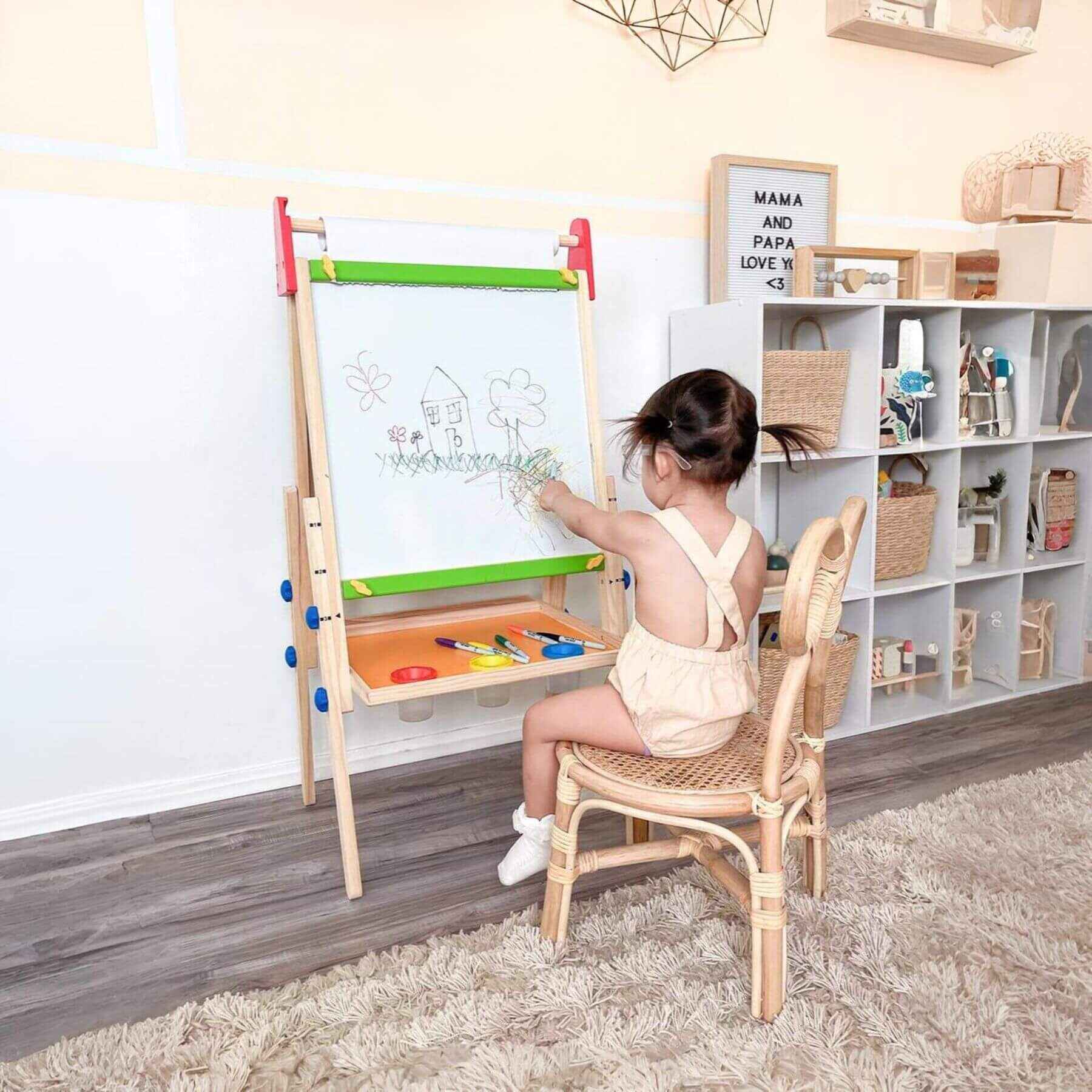 Child drawing on Tiny Land® 3-in-1 Art Easel & Paper Roll Set in a home setting