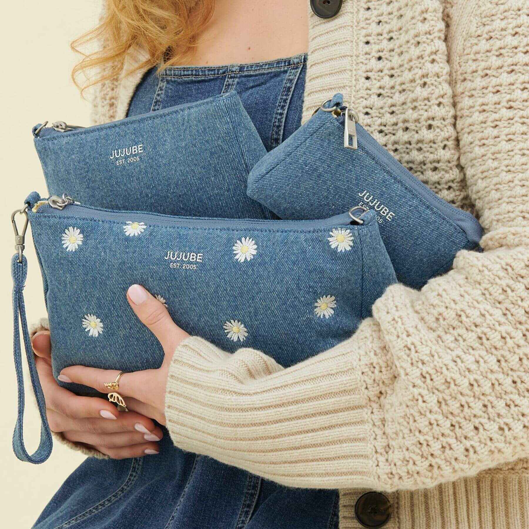 Person holding JuJuBe 3-piece Pouch Clutch Purse Set - Denim & Daisies