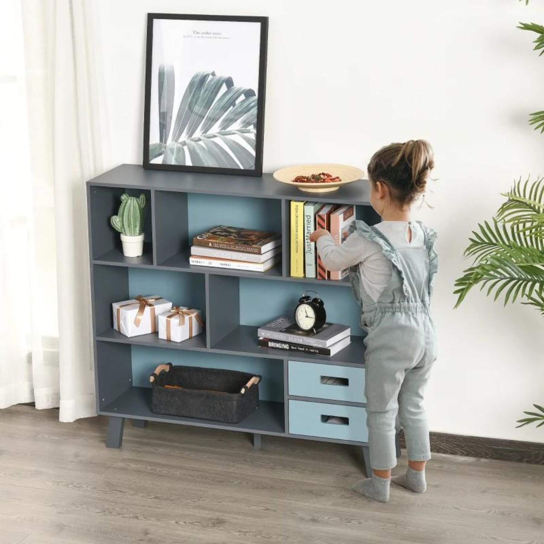 Girl Putting Books on HOMCOM 3-Tier Child Bookcase Dark Blue