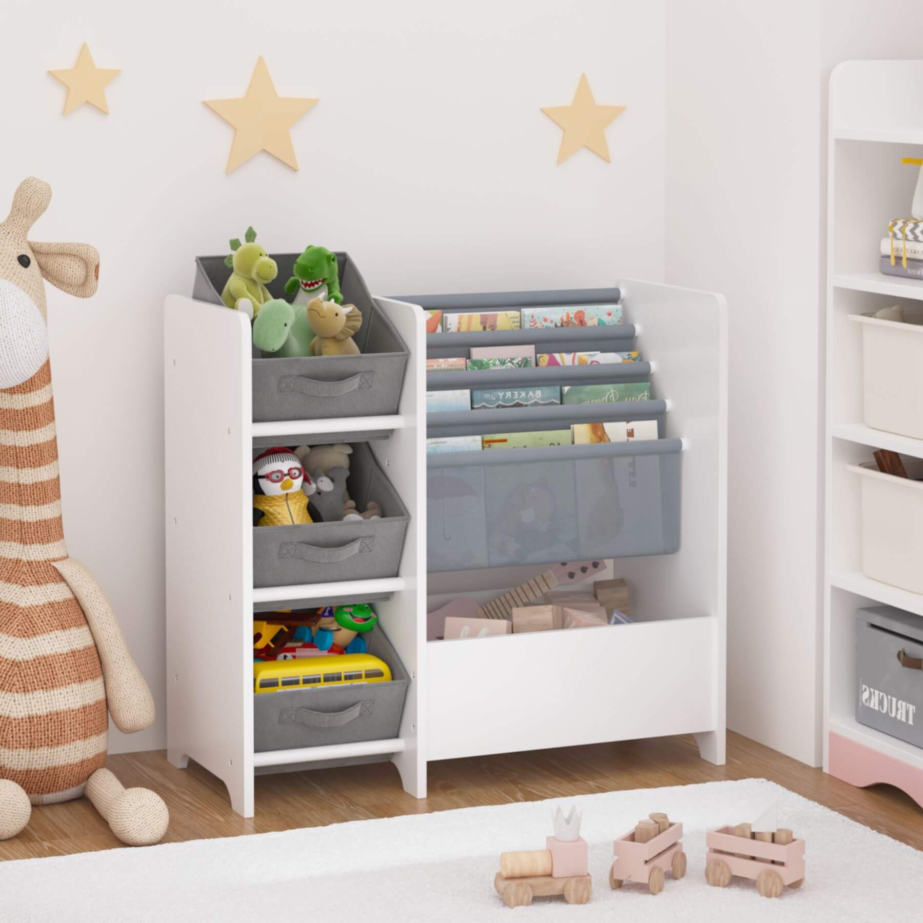 Children's toy storage unit with bins and books in a room with toys and decor.