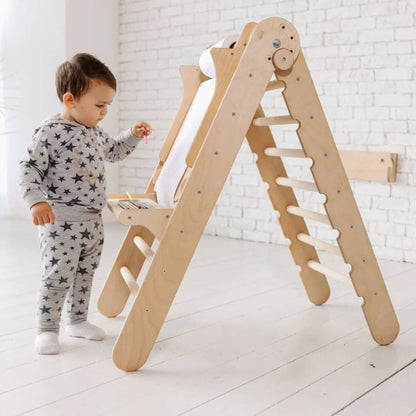 Child playing with Goodevas wooden climbing toy in a bright room.