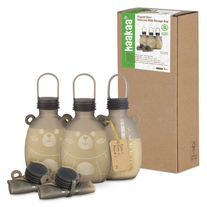 Three beige bottles with bear designs and a cardboard box labeled 'haakaa' on a white background.