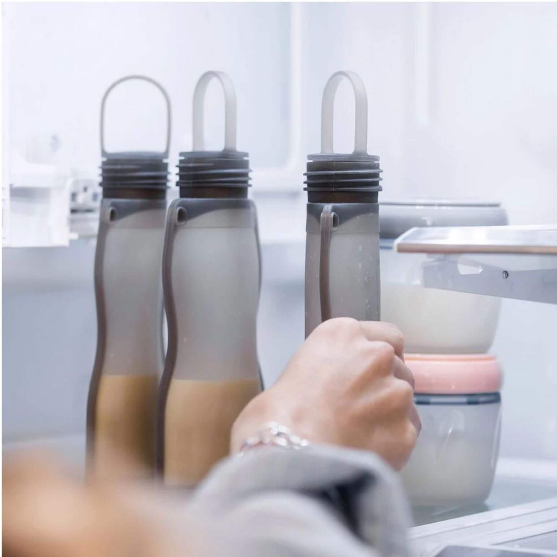 Hand reaching Haakaa Silicone Milk Storage Bag 9oz