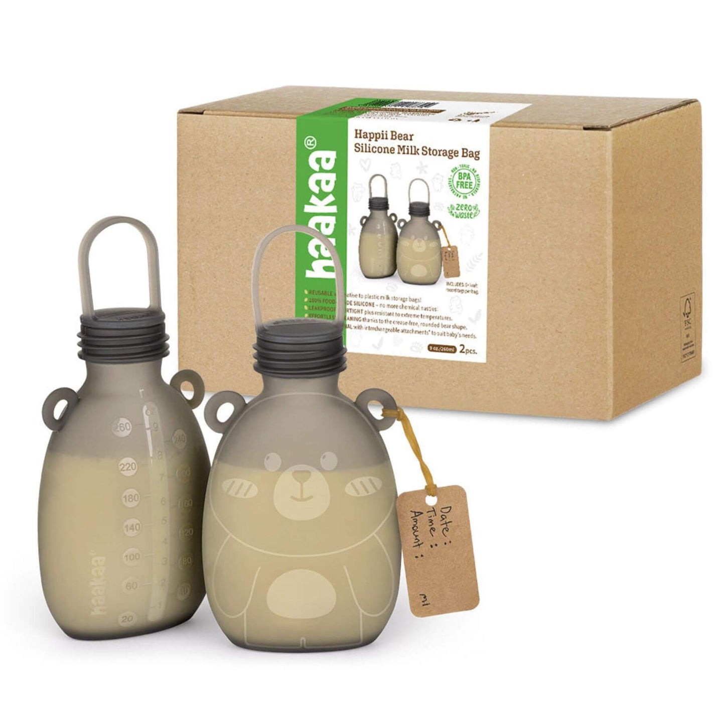 Two beige silicone milk storage bags with a bear design next to their packaging box on a white background.