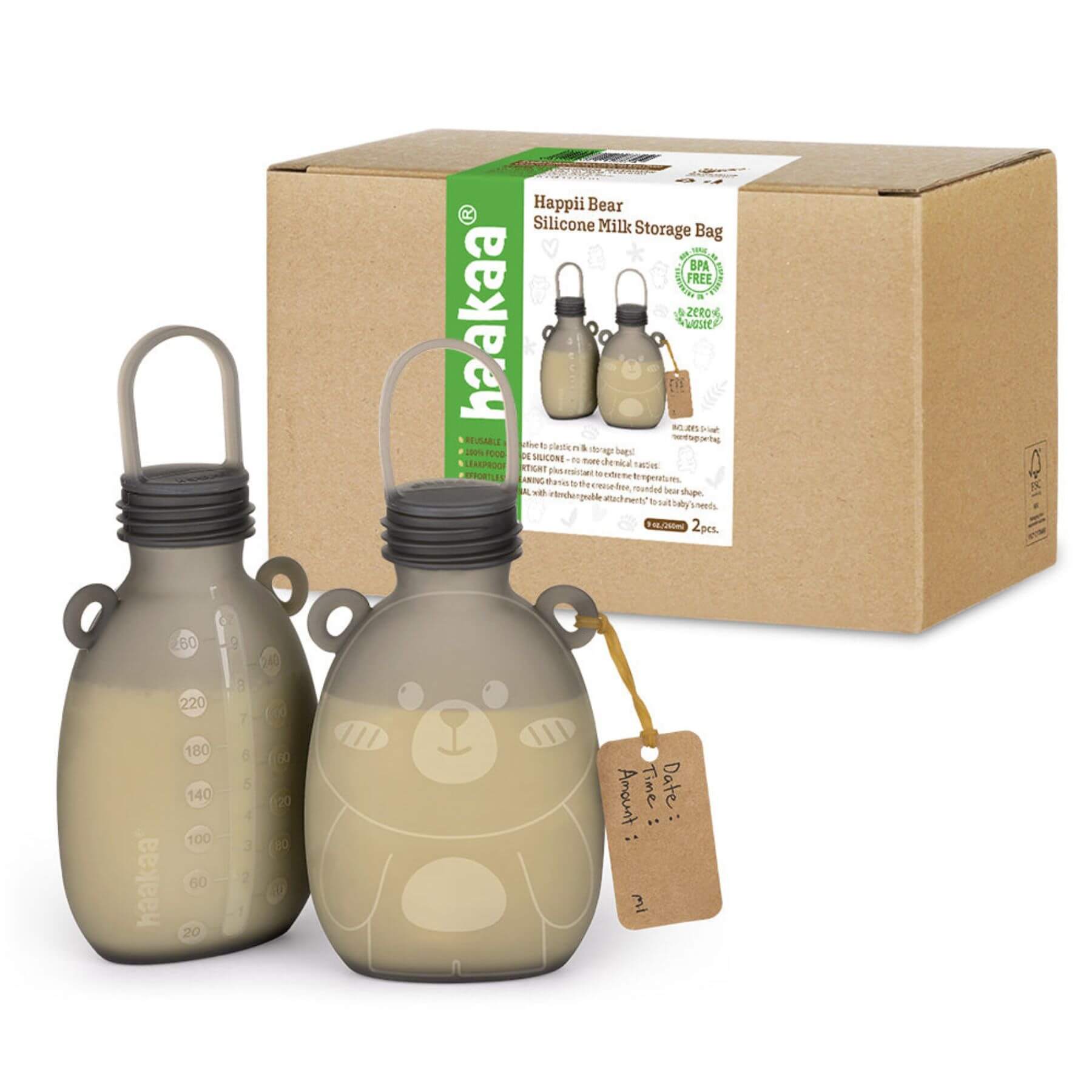 Two beige silicone milk storage bags with a bear design next to their packaging box on a white background.