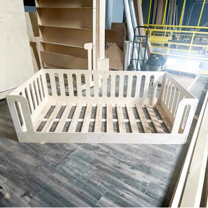 Bush Acres AVI- Floor Bed on a wooden floor with construction materials in the background