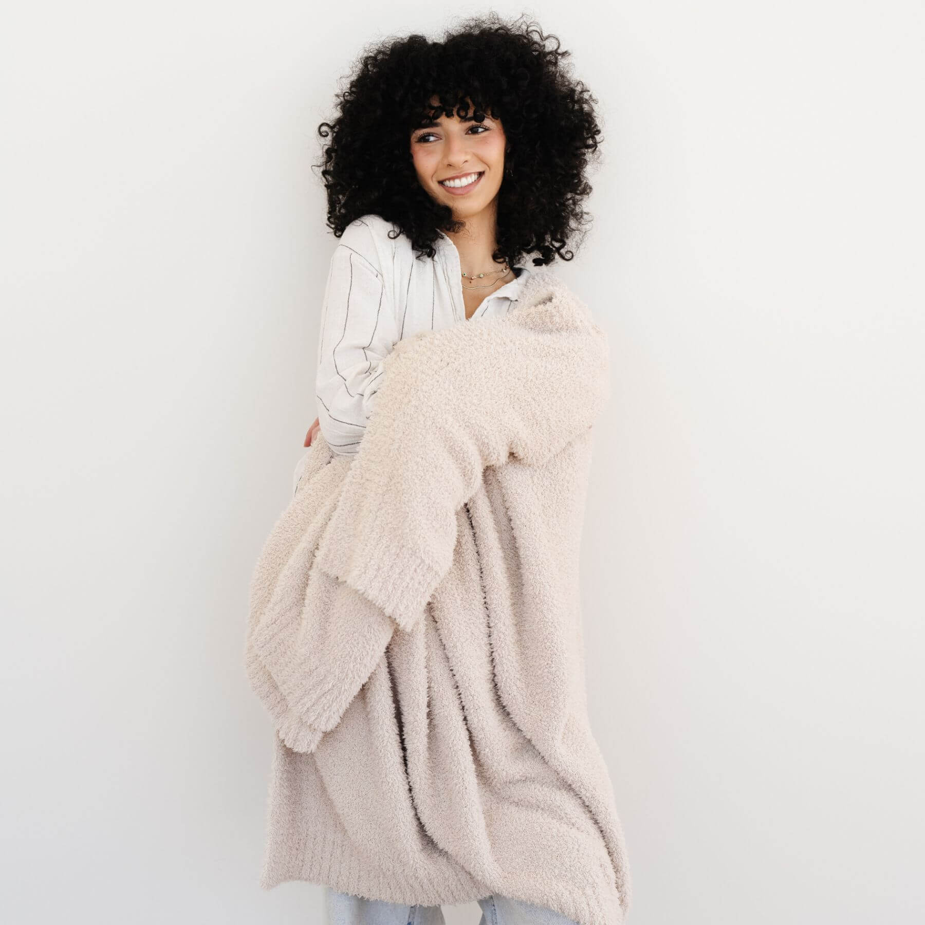 Woman holding BAMBONI® XL Blanket - Buttermilk against a white background