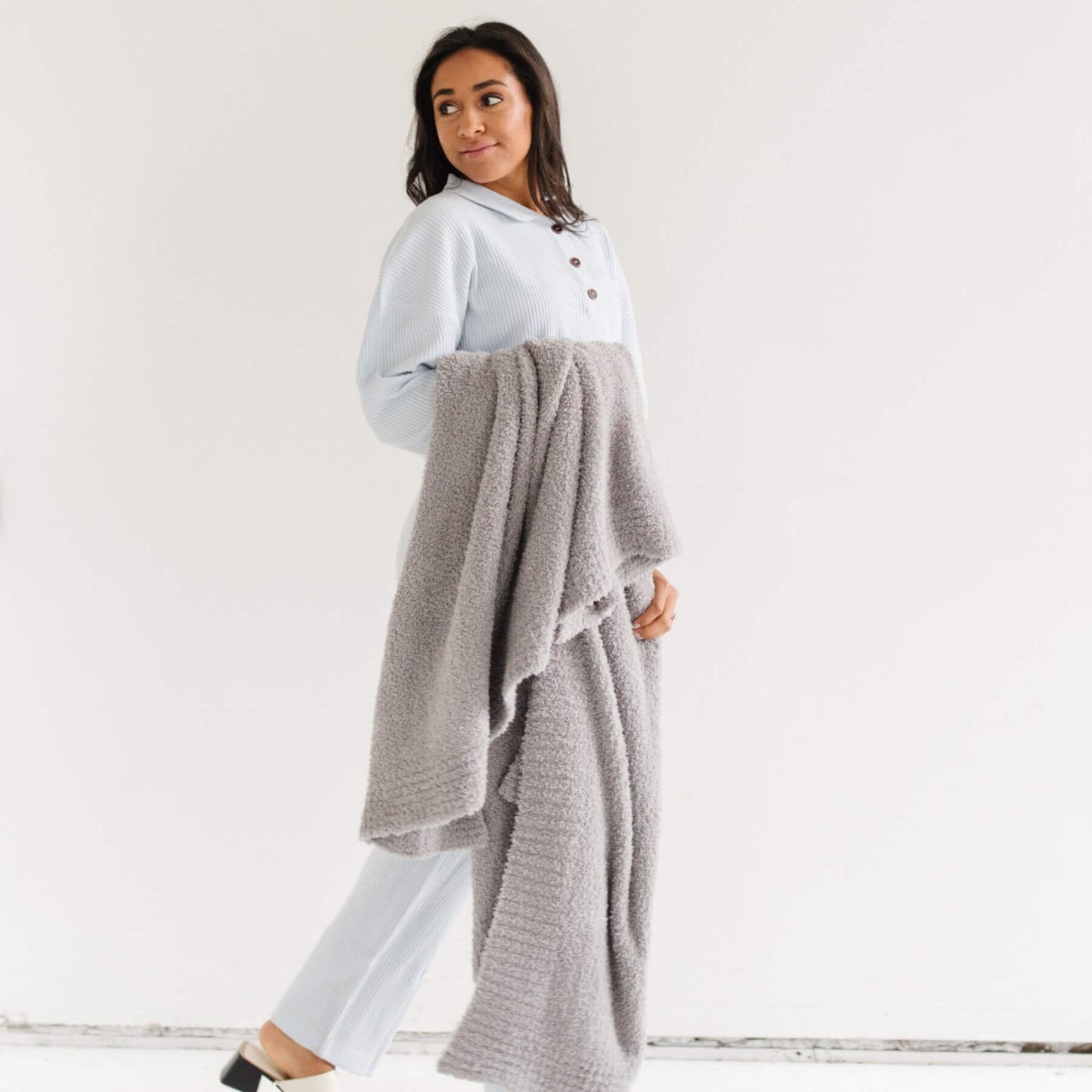 Woman holding BAMBONI® XL Blanket - Gray against a white background