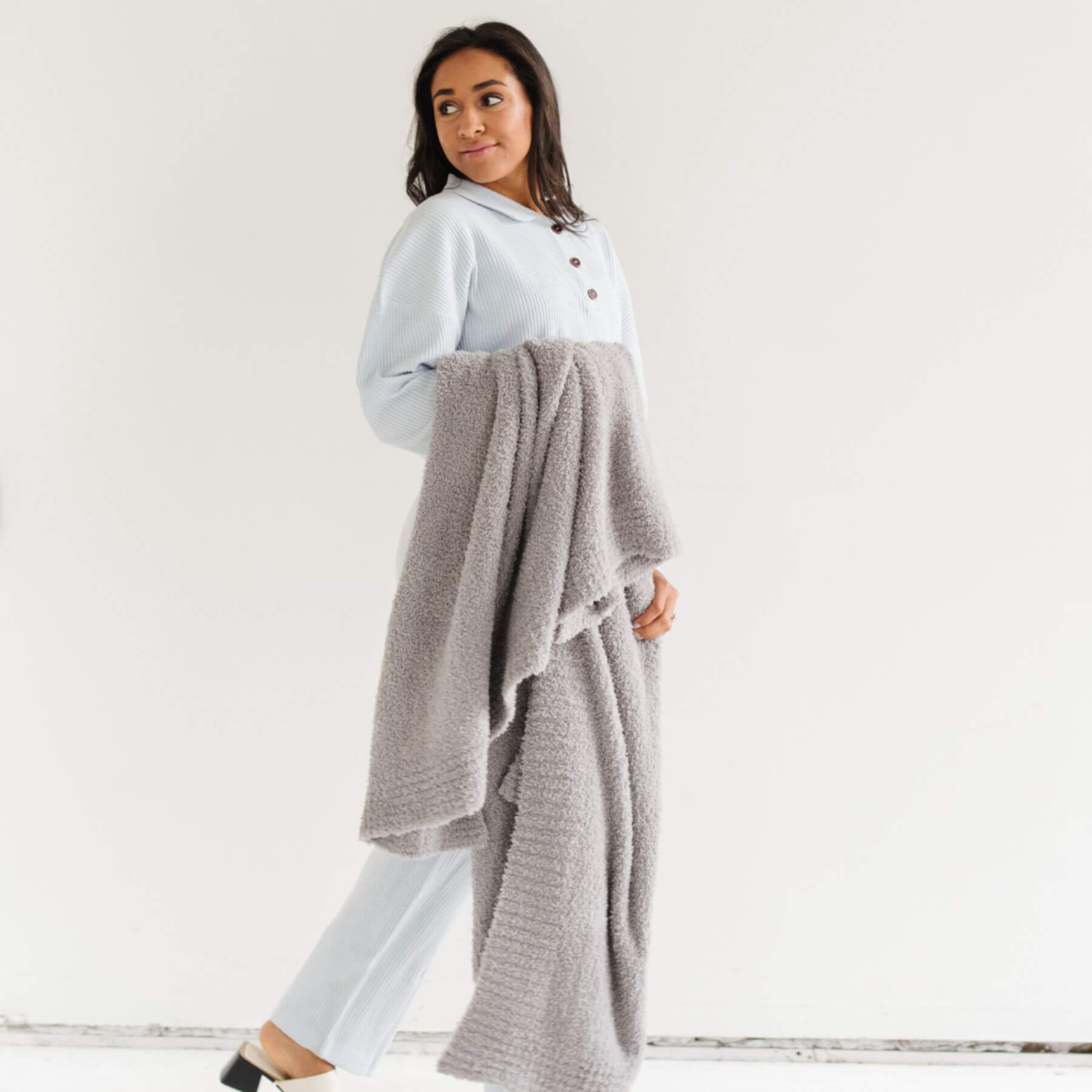 Woman holding BAMBONI® XL Blanket - Gray against a white background