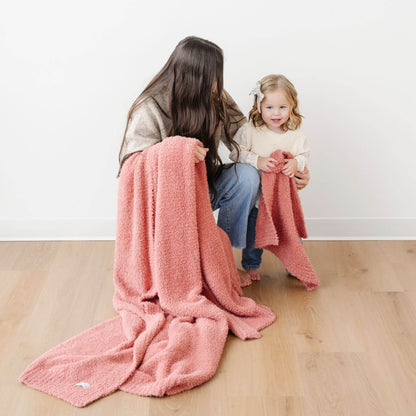 Woman and child sitting on a wooden floor with BAMBONI® XL Blanket - Hibiscus