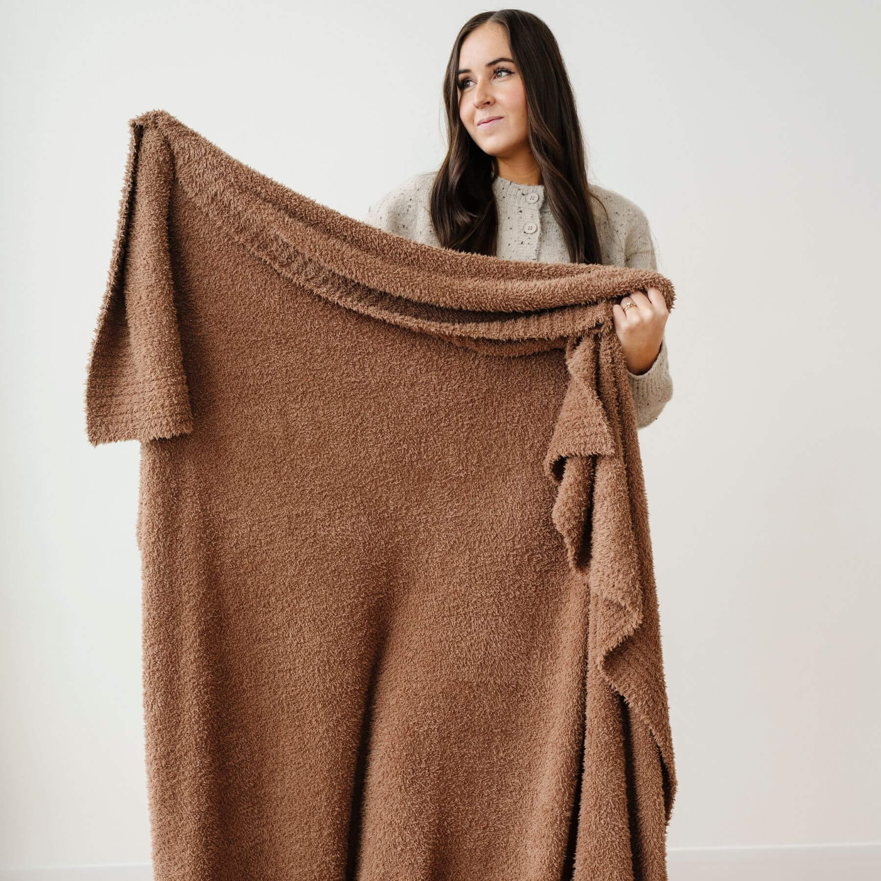 Woman holding BAMBONI® XL Blanket - Pecan against a white background