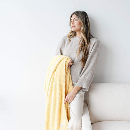 Woman holding BAMBONI® XL Blanket - Sunburst against a white background