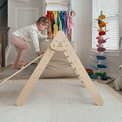 Child playing on a wooden climbing toy in a room with colorful toys and decorations.