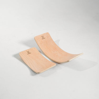 Two wooden balance boards on a light gray background