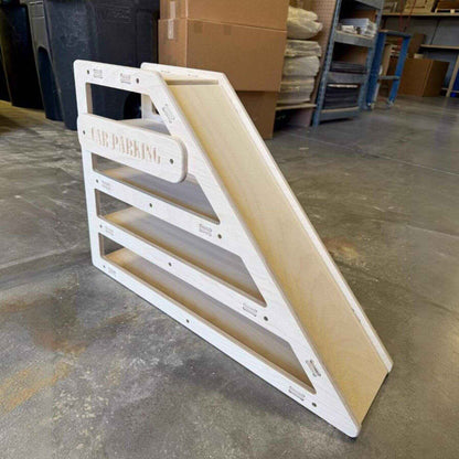CAMDEN- Toy Car Storage + Ramp on a concrete floor in a warehouse setting.