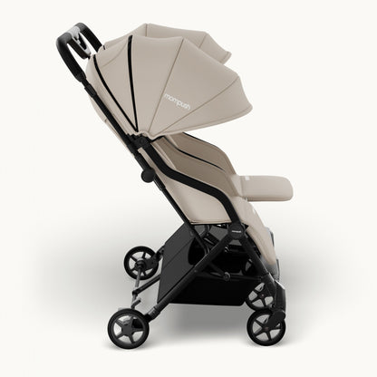 A compact double stroller in beige and black, shown from a side profile view against a clean white background. The brand name 'monopush' is visible on the canopy.