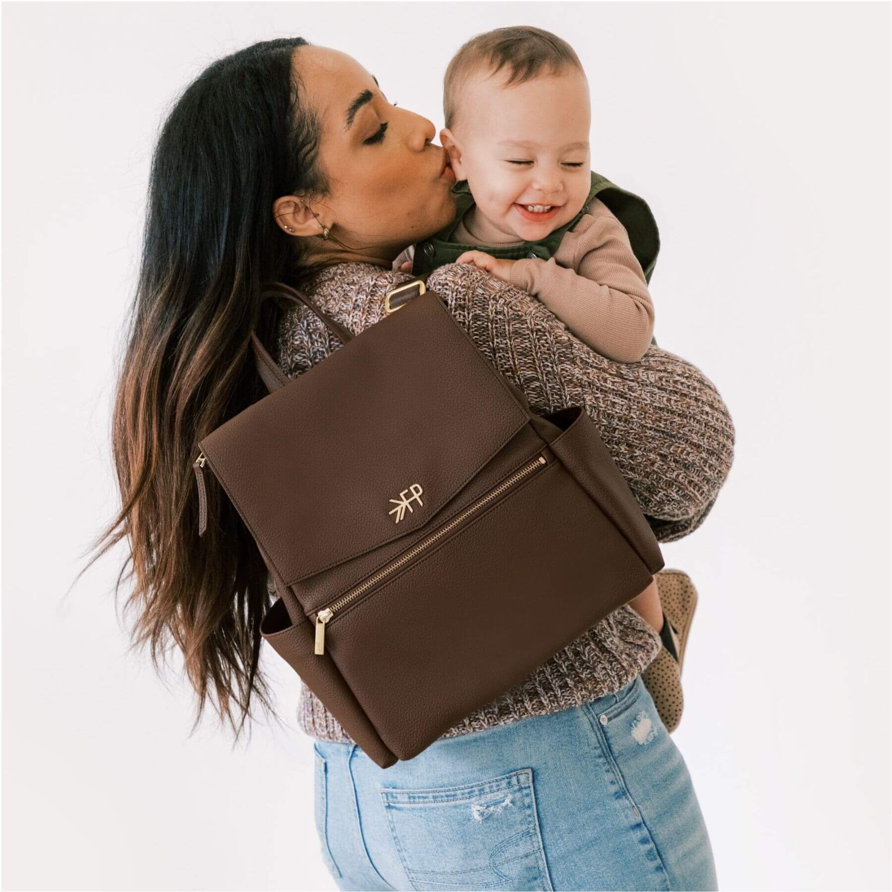 Woman carrying a baby and Freshly Picked Espresso Mini Classic Diaper Bag II