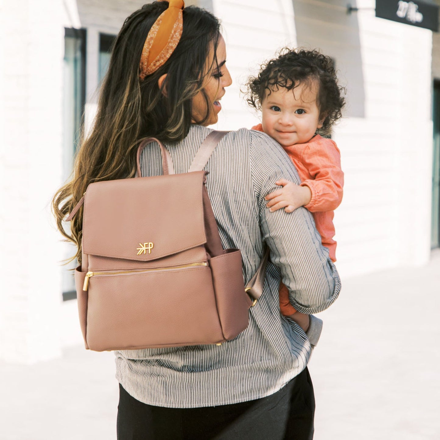 Woman carrying a baby and Freshly Picked Heather Mini Classic Diaper Bag II