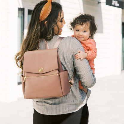 Woman carrying a baby and Freshly Picked Heather Mini Classic Diaper Bag II