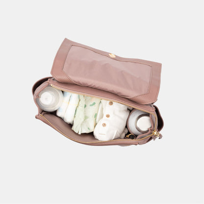 Freshly Picked Heather Mini Classic Diaper Bag II with baby items on a light gray background