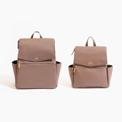 Two brown diaper backpacks with a visible brand logo on a white background