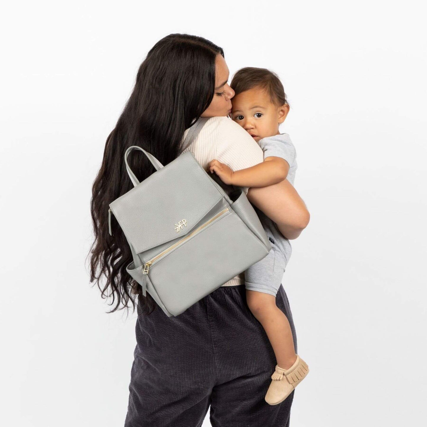 Woman holding a baby and Freshly Picked Stone Mini Classic Diaper Bag II
