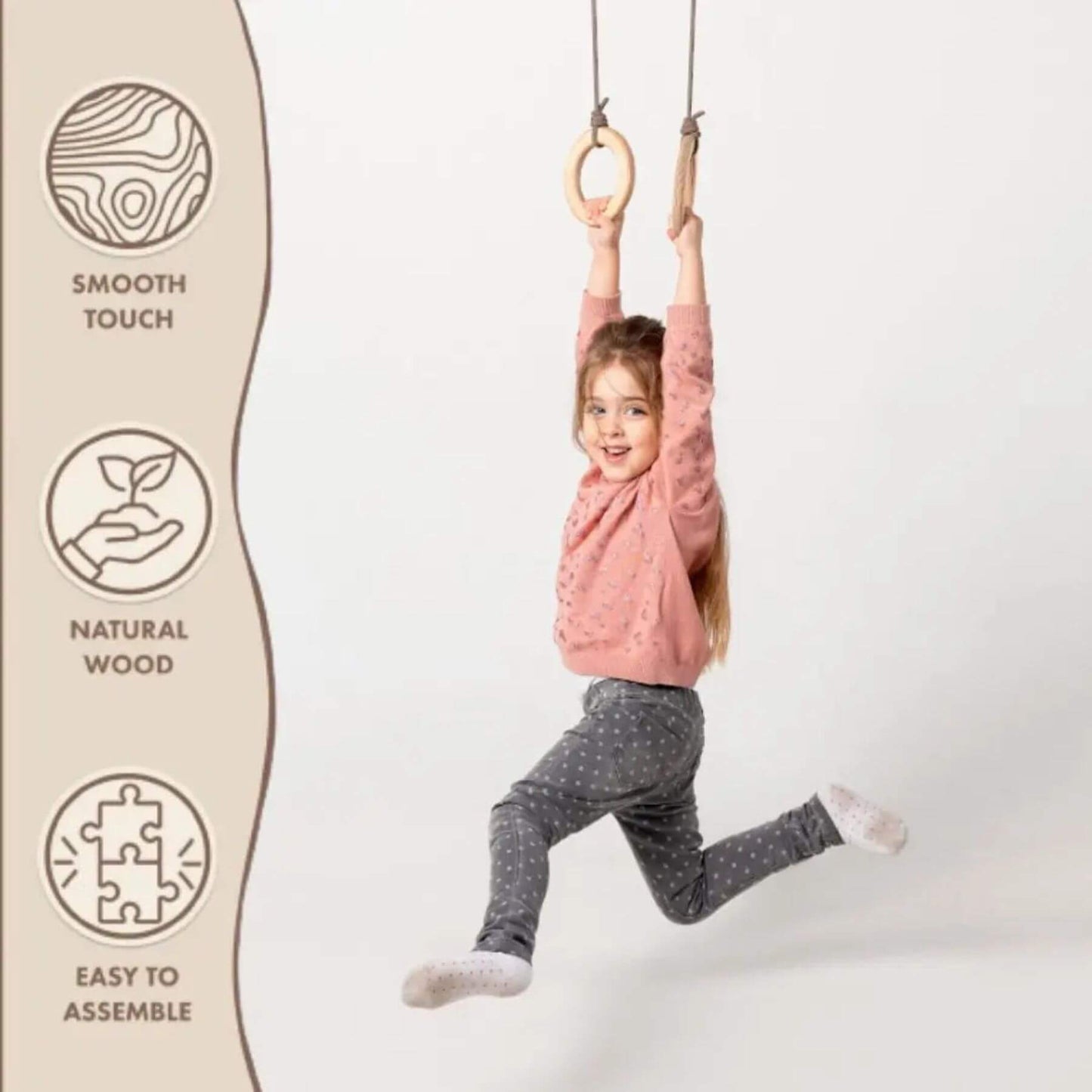 Child playing on Goodevas Wooden Gymnastic Rings with product features on the side.