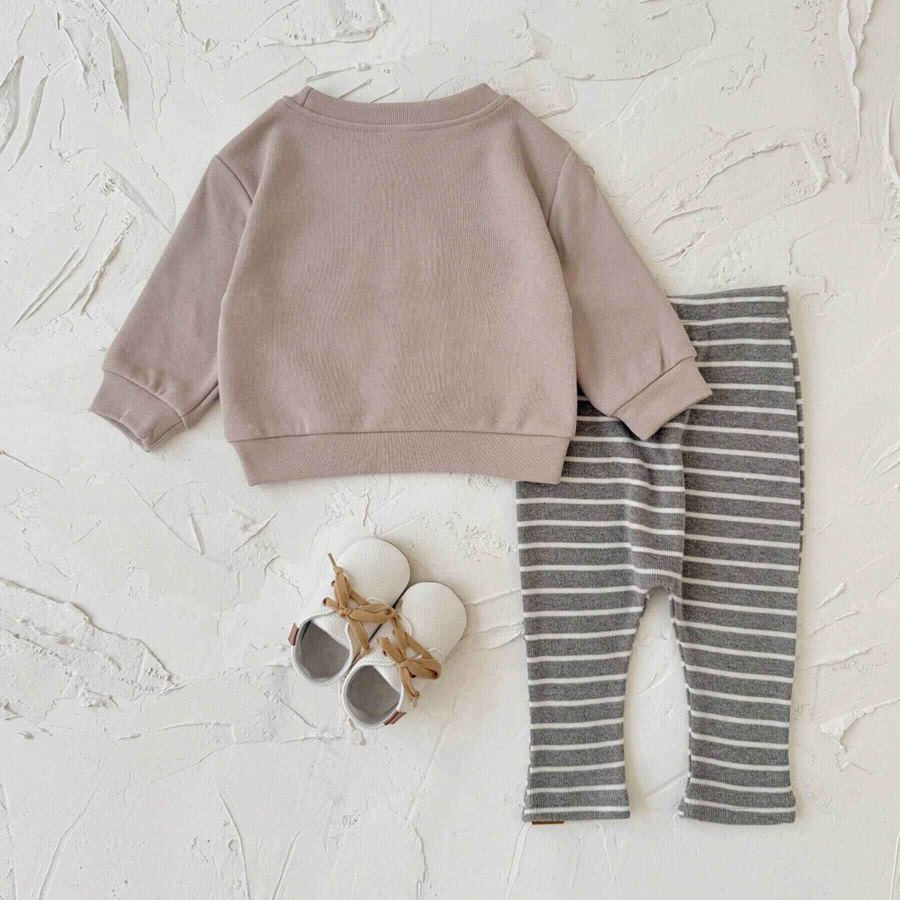 RYAN AND REMI HELLO Striped Pants Set on a light textured surface.