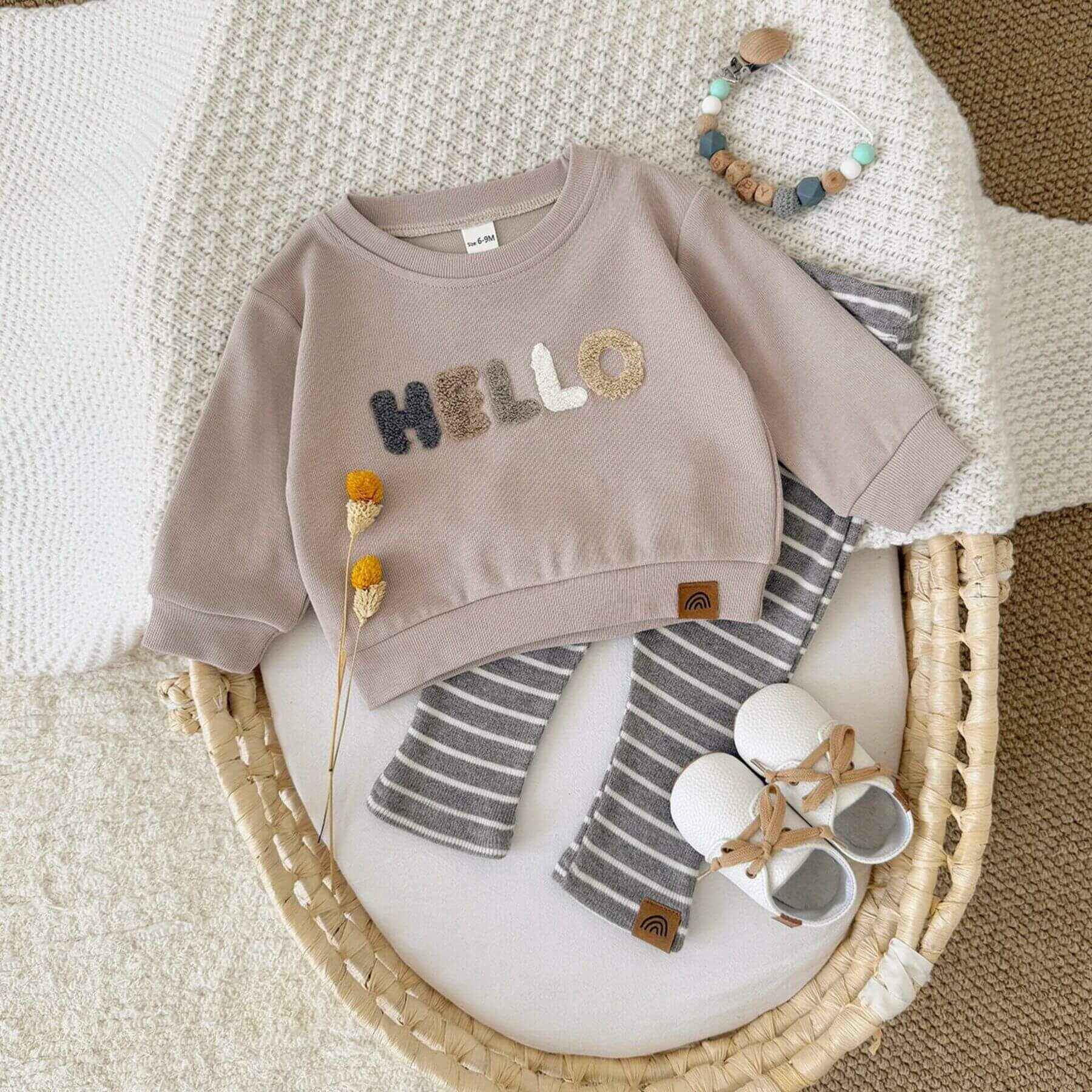 RYAN AND REMI HELLO Striped Pants Set on a textured surface.