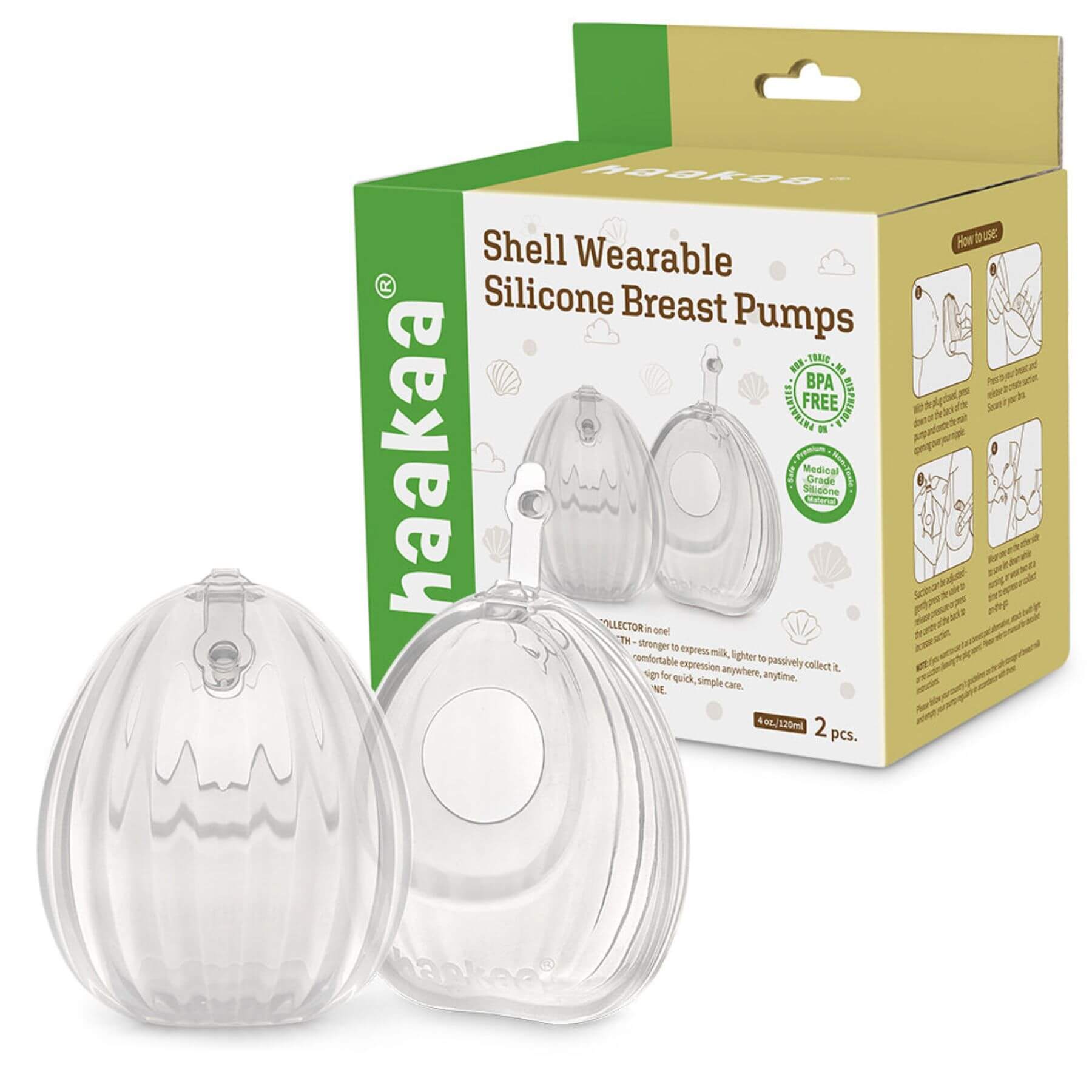 Clear shell-shaped silicone breast pumps with packaging displaying 'haakaa' brand on a white background.