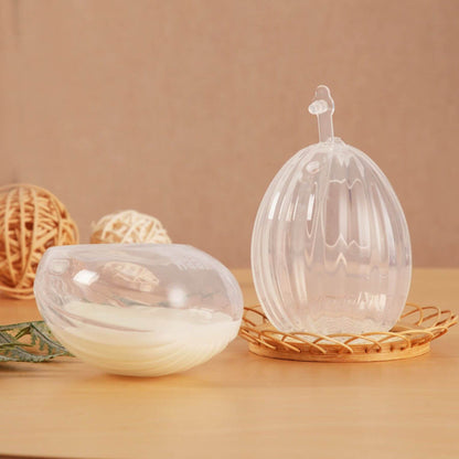 Haakaa Shell Wearable Silicone Breast Pump on a wooden surface with a beige background
