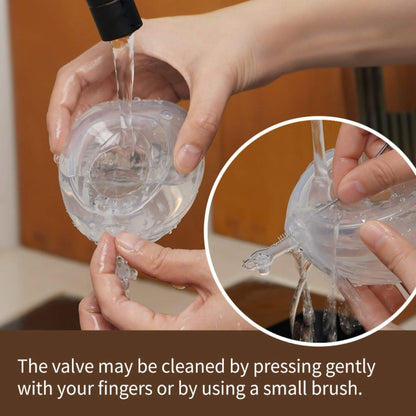 Person cleaning Haakaa Shell Wearable Silicone Breast Pump using water and their fingers.