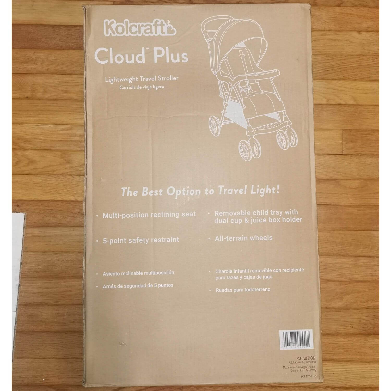 A tall, flat cardboard box for the Kolcraft Cloud Plus Lightweight Travel Stroller