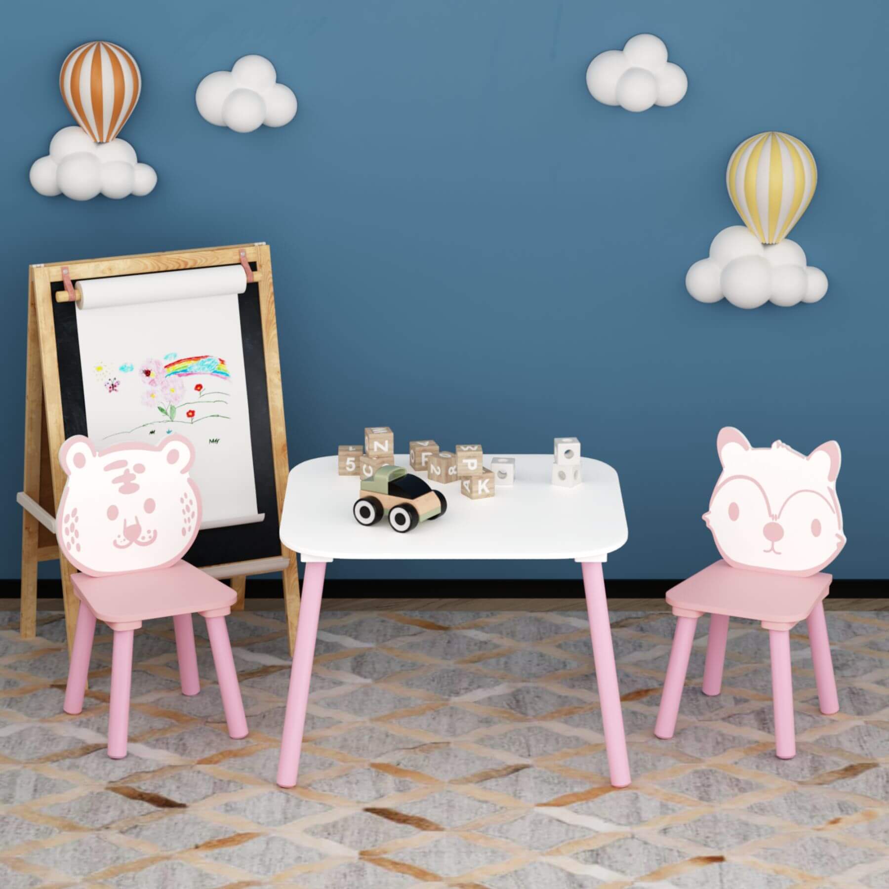 Children's play area with MOONRIVER 3-Piece Wooden Toddler Desk with Animal Backrest - Pink & White against a blue wall with cloud and balloon decorations.