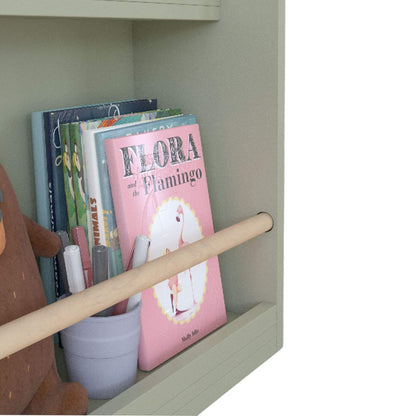 Children's books on a shelf with a pink book titled 'Flora and the Flamingo'.