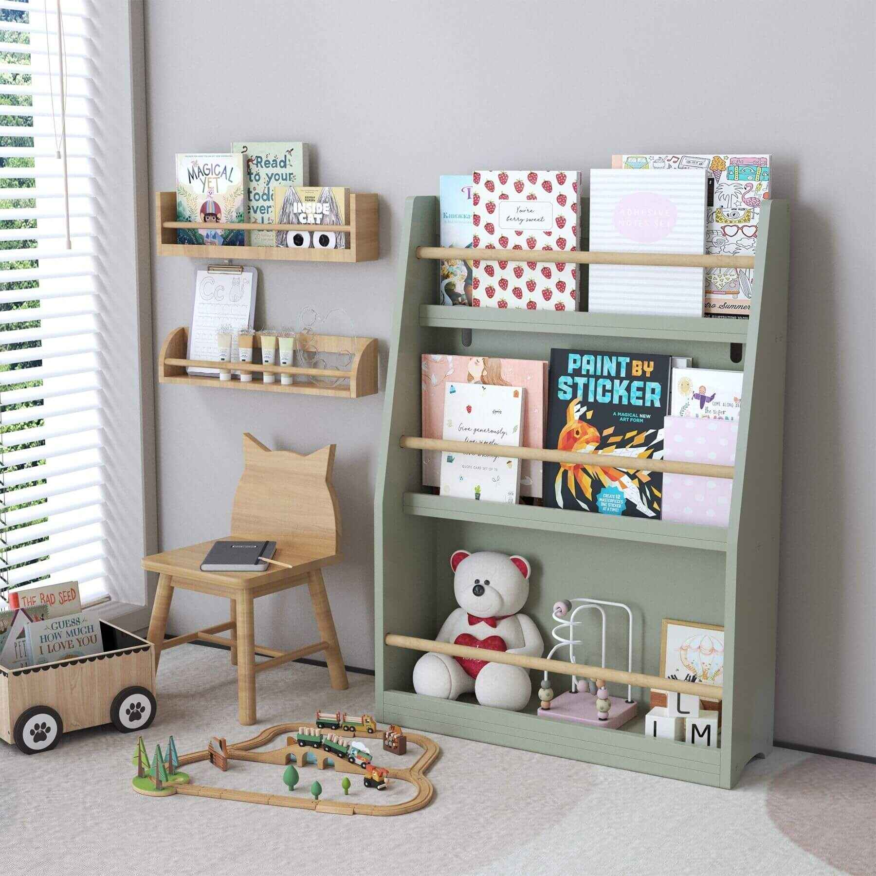 MOONRIVER 3 Tier Kids Book Shelf - Sage with books and toys in a room with a window and chair.