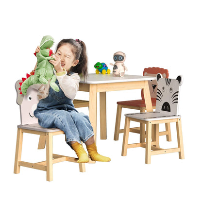 Child playing with toys at a table with animal-themed chairs on a white background