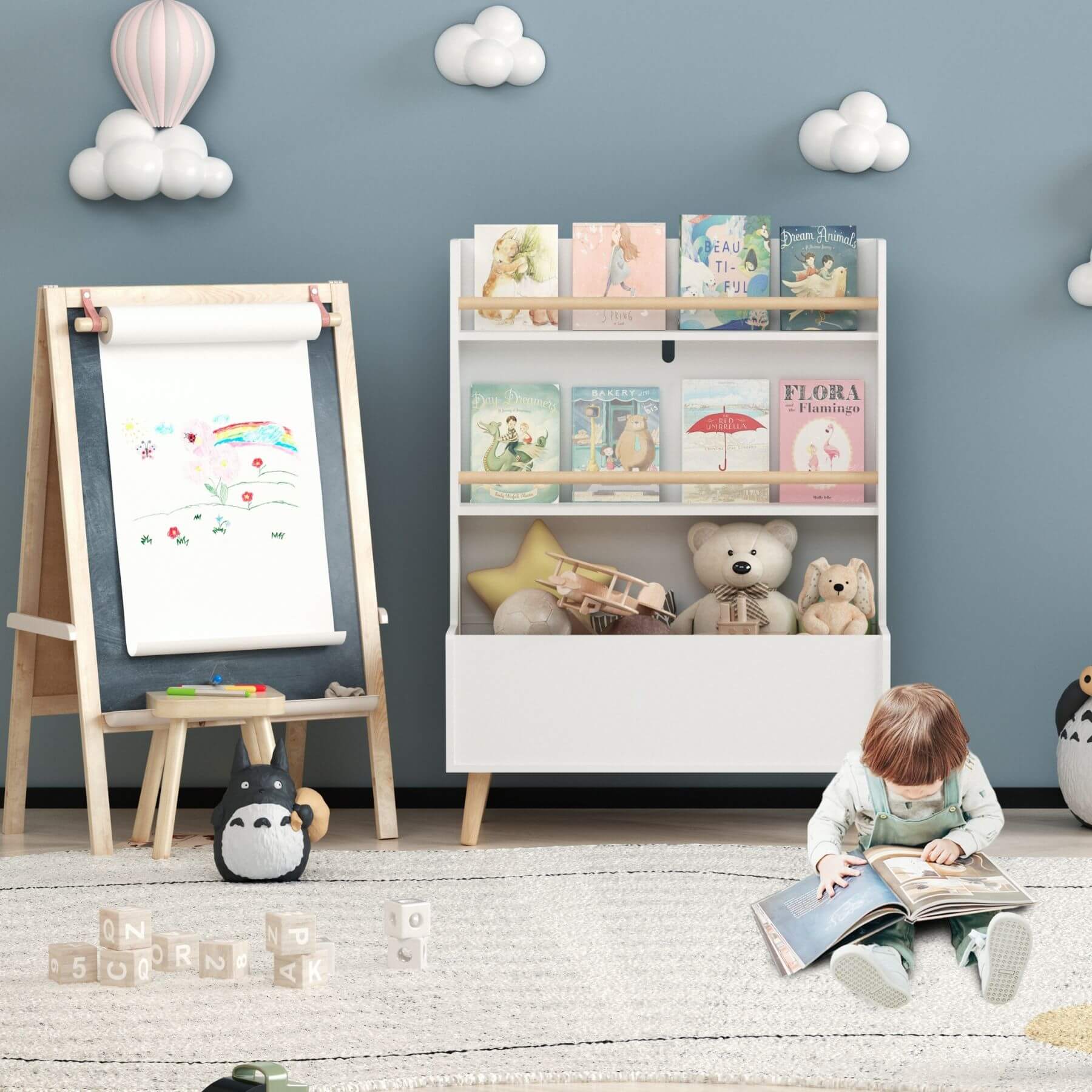Child reading a book in a playroom with MOONRIVER Kids Bookshelf MDF and Pine Legs - White, easel, and toys.