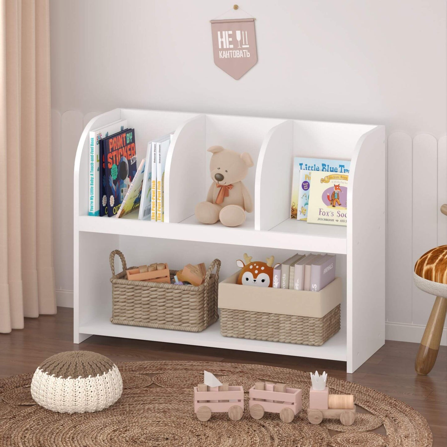 White children's bookshelf with toys and books in a room setting.