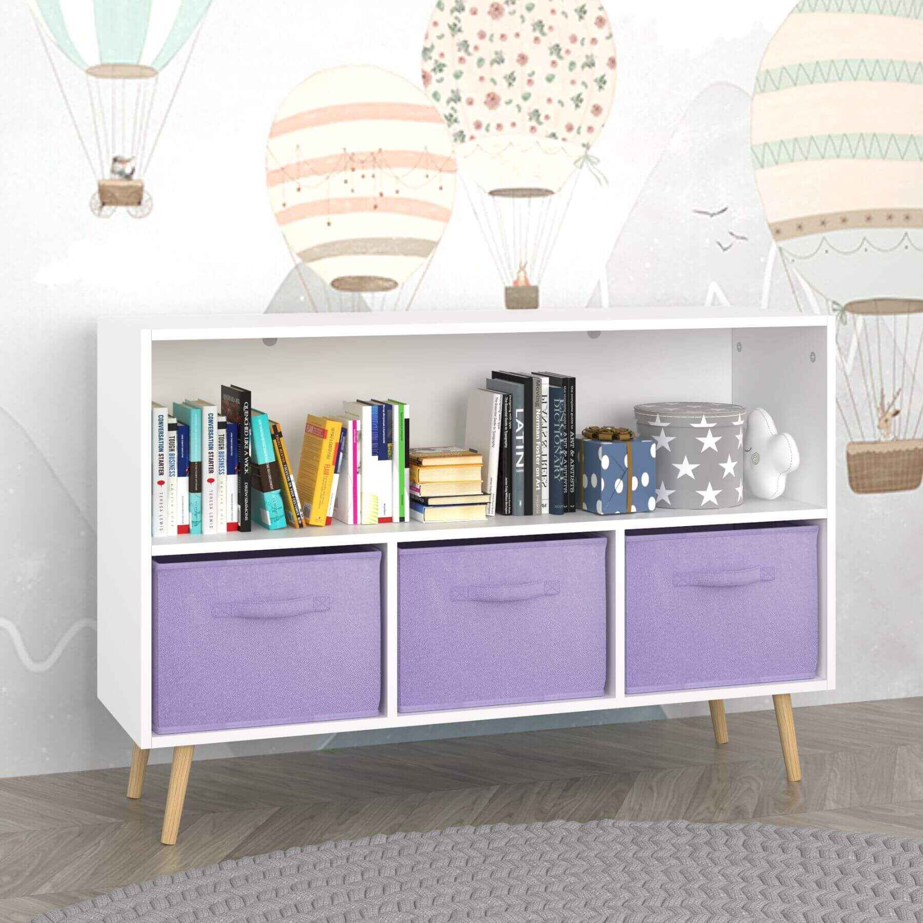 White storage unit with purple bins and books against a white wall with hot air balloon decorations.