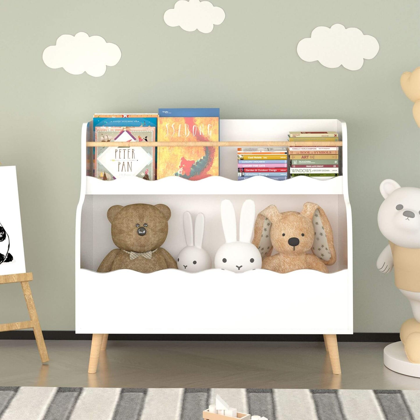 Children's bookshelf with books and toys against a wall with cloud decorations