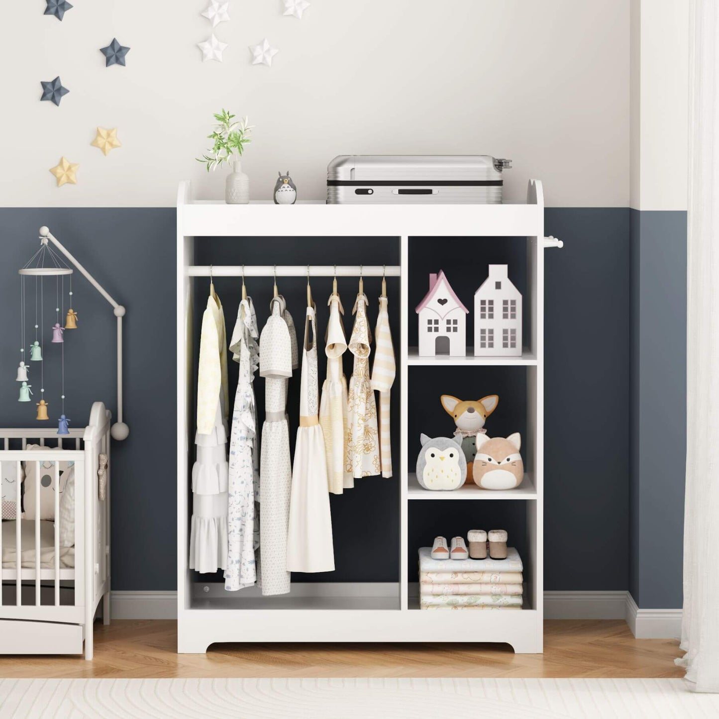 White changing table with clothes and toys in a nursery setting