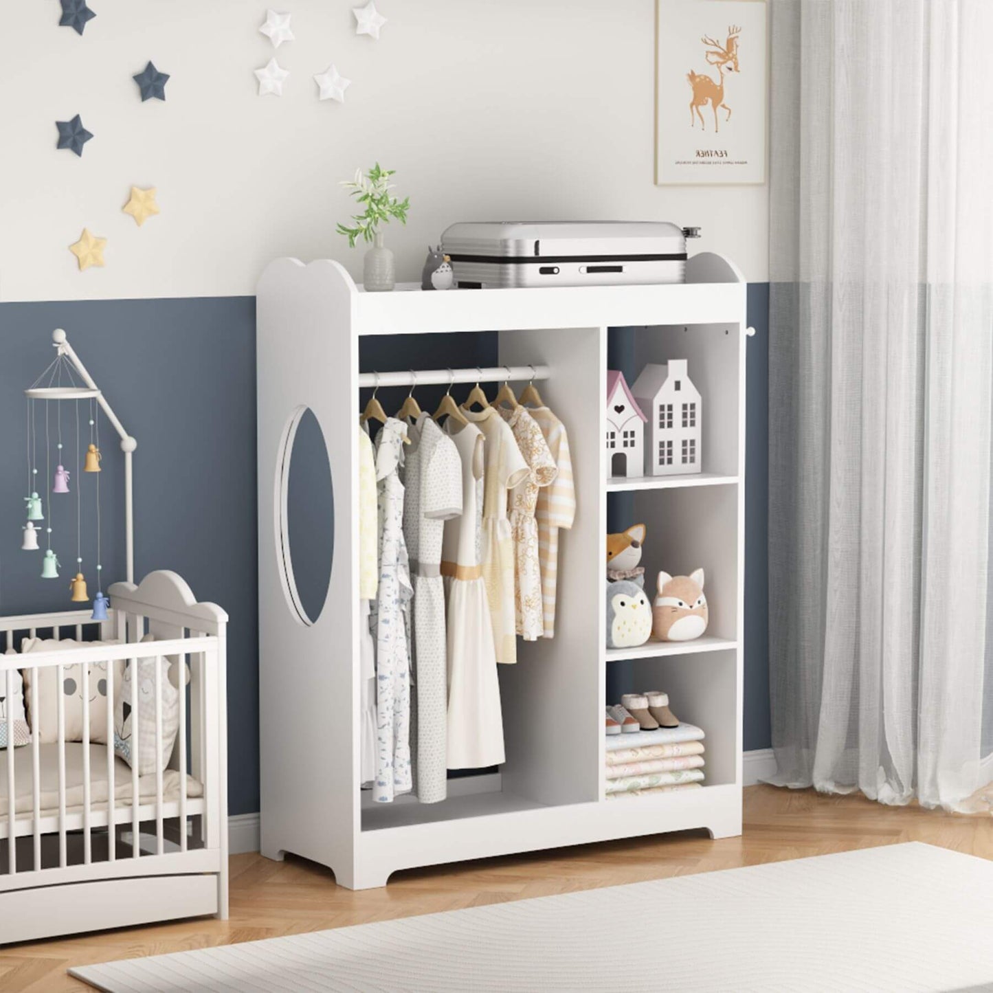 Children's room with a white wardrobe, crib, and decorative items.