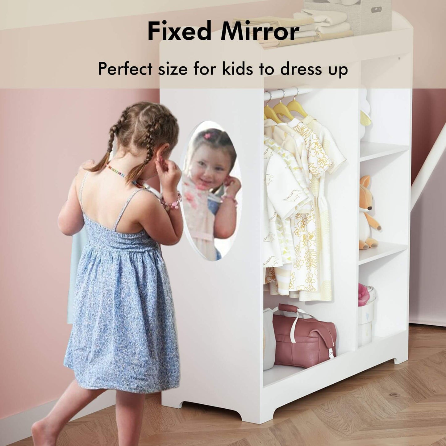Child looking at a fixed mirror in a children's wardrobe with clothes and toys.