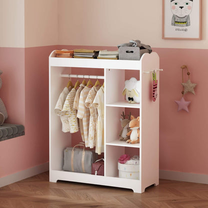 Children's wardrobe with clothes and toys in a room with pink walls.