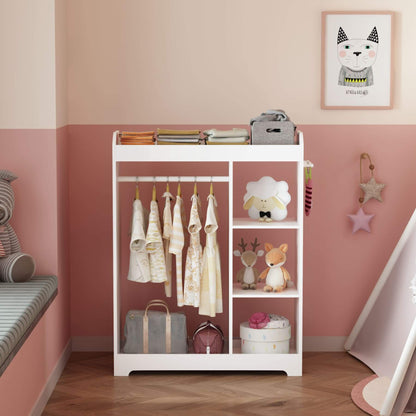 White children's clothing rack with clothes and toys against a pink wall.