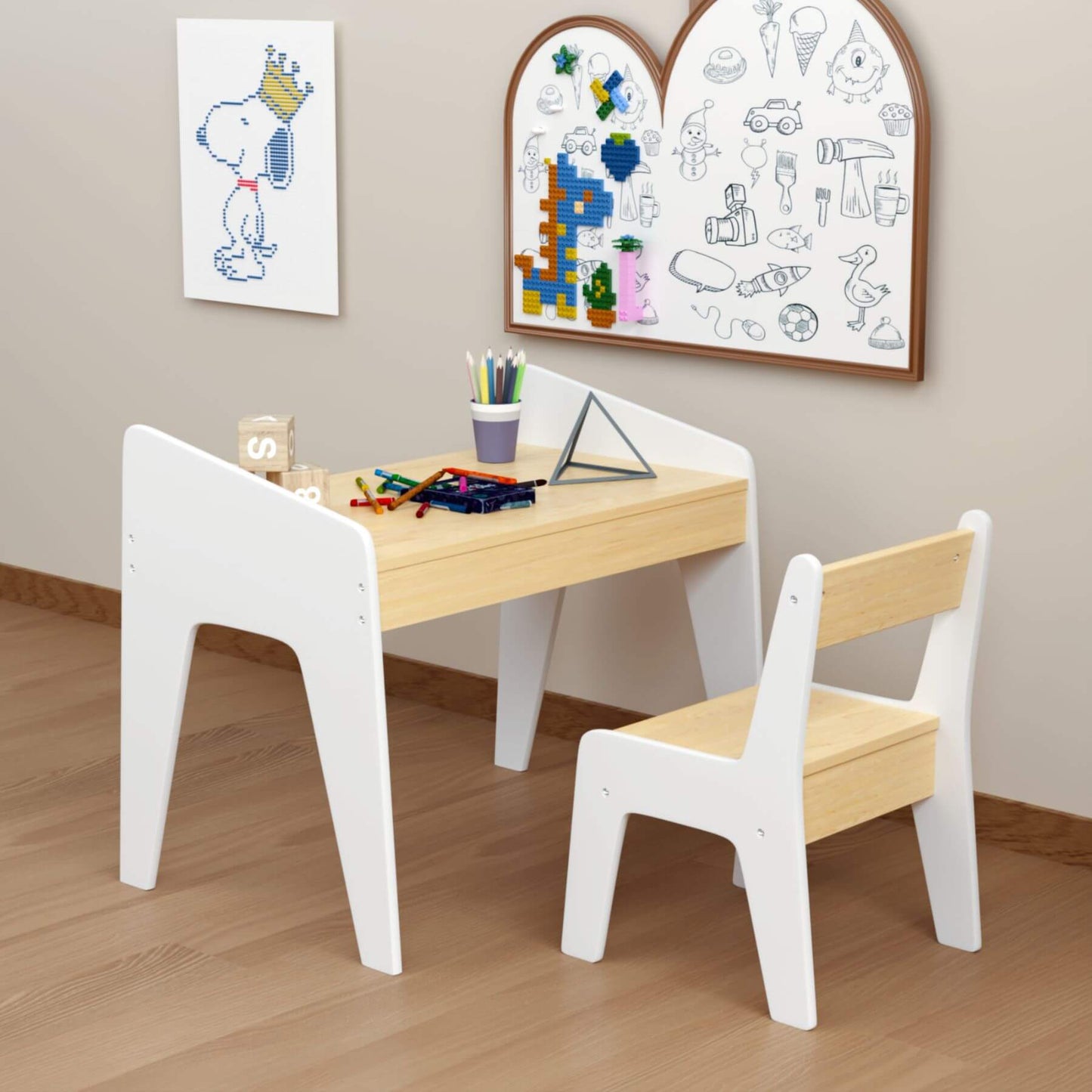 Children's wooden table and chair set with art supplies and drawings on a wall.