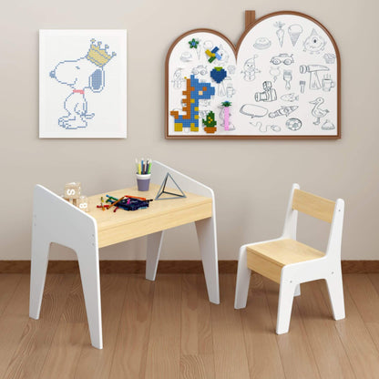 Children's table and chair set with wall art in a room.